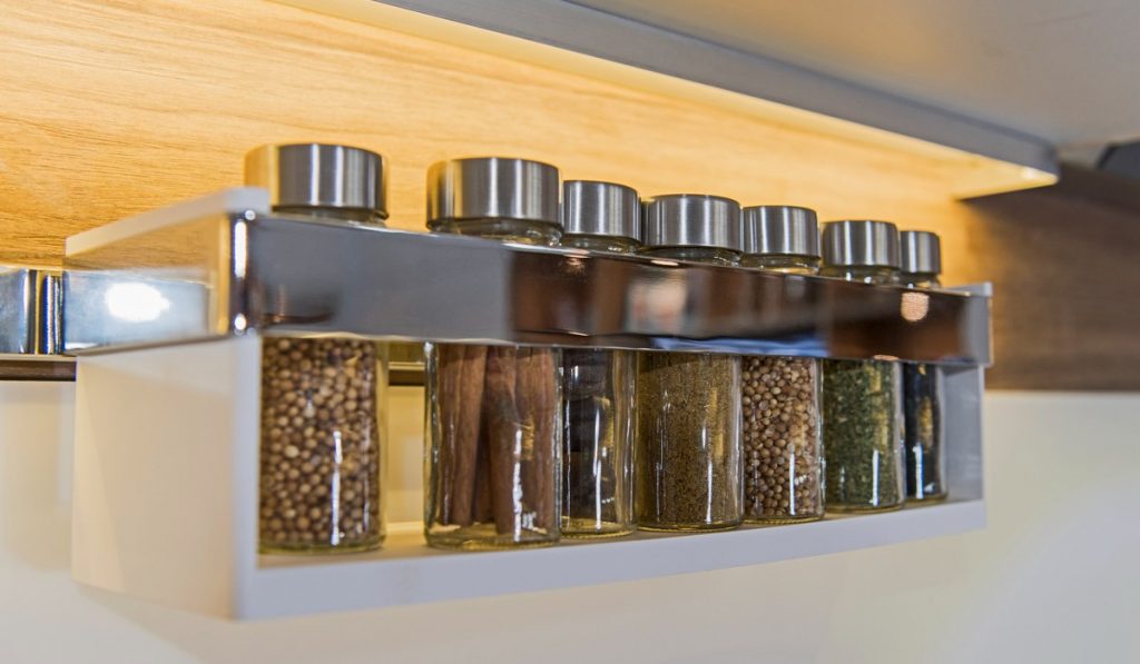 wall spice racks are neat and add to a neat looking kitchen