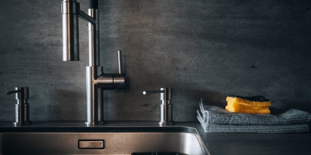 Close-up of faucet and sink in the modern luxury kitchen
