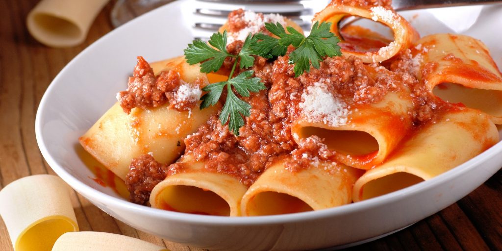Paccheri Neapolitans with meat sauce in the white dish