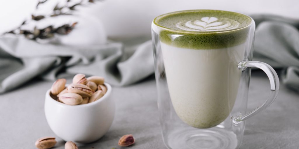 Green matcha latte with pistachios