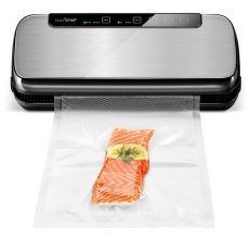 The NutriChef food vacuum sealer while sealing a piece of salmon.